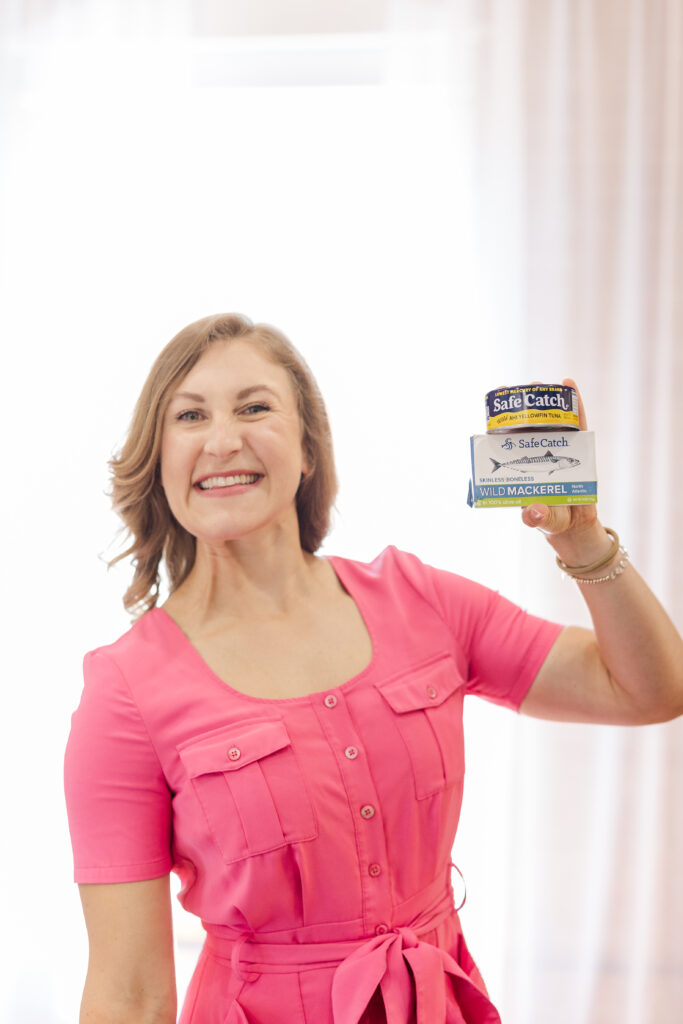 Whitness Nutrition Blogger Whitney Stuart shares Five High Protein Canned Fish Recipes - in photo: Whitney holding canned fish